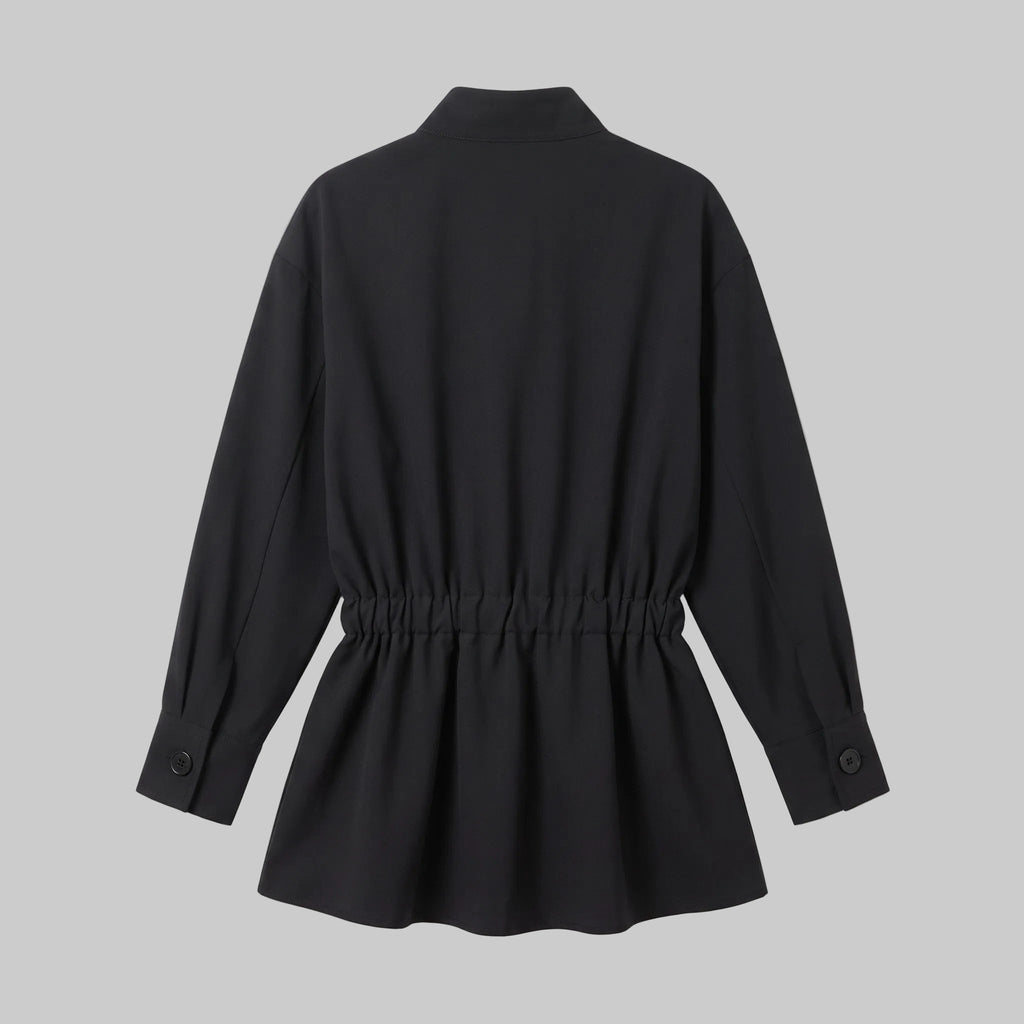 Model wearing the Celeste black belted shirt mini dress with long sleeves, button-front detailing, and a pleated mini skirt.