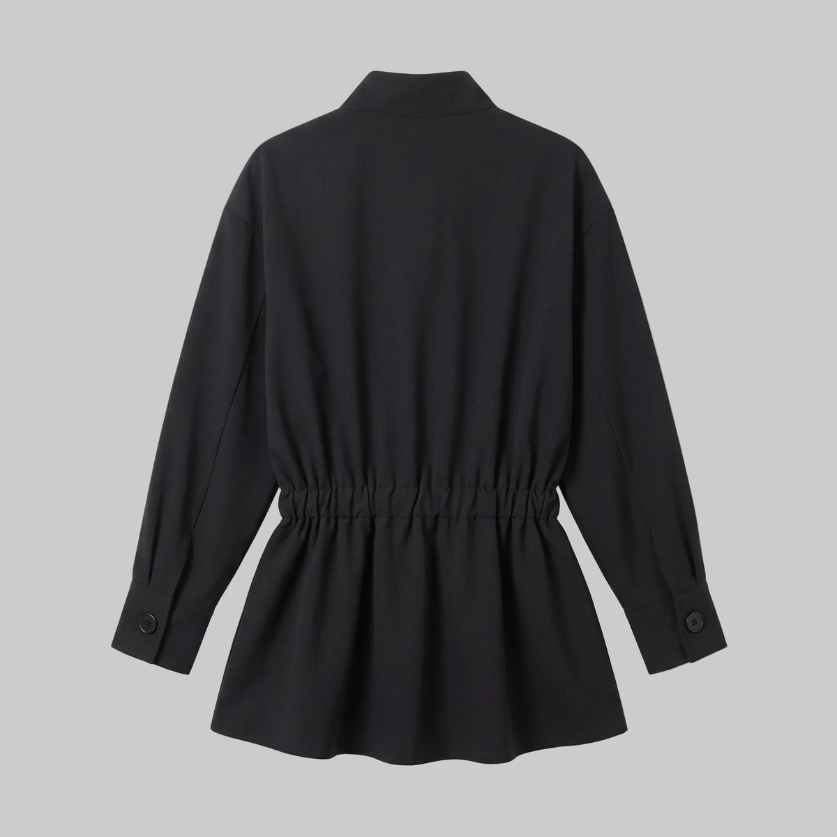 Model wearing the Celeste black belted shirt mini dress with long sleeves, button-front detailing, and a pleated mini skirt.