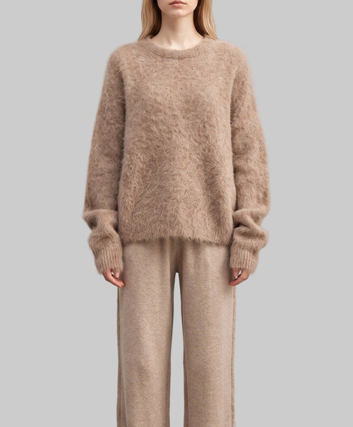 Model wearing the Alba taupe alpaca sweater with a soft fuzzy texture and relaxed fit