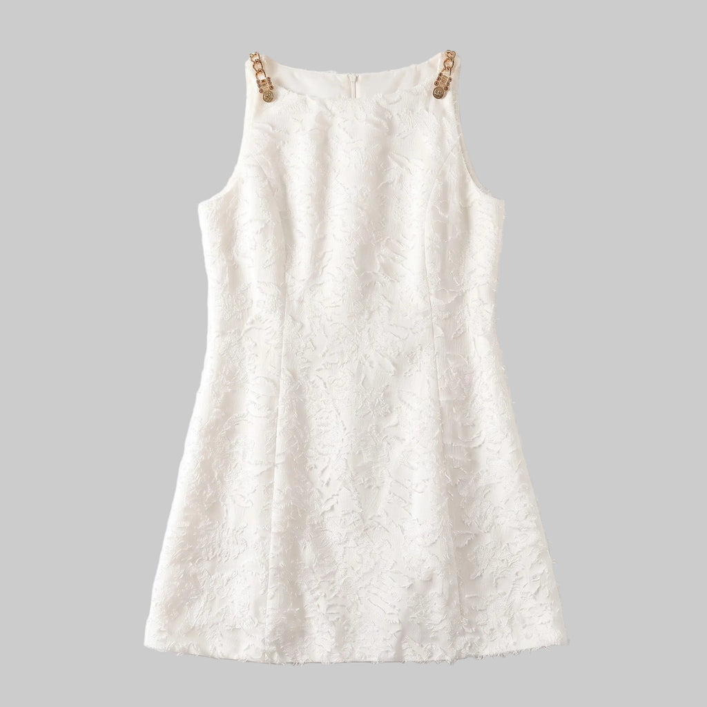 Model wearing the Lucia ivory jacquard mini dress with textured floral fabric and gold-tone shoulder details