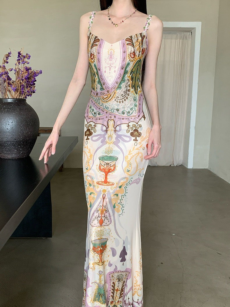 LUNRIA Baroque Chalice Print Satin Slip Maxi Dress with spaghetti straps and a square/scoop neck. Features a luminous sheen.