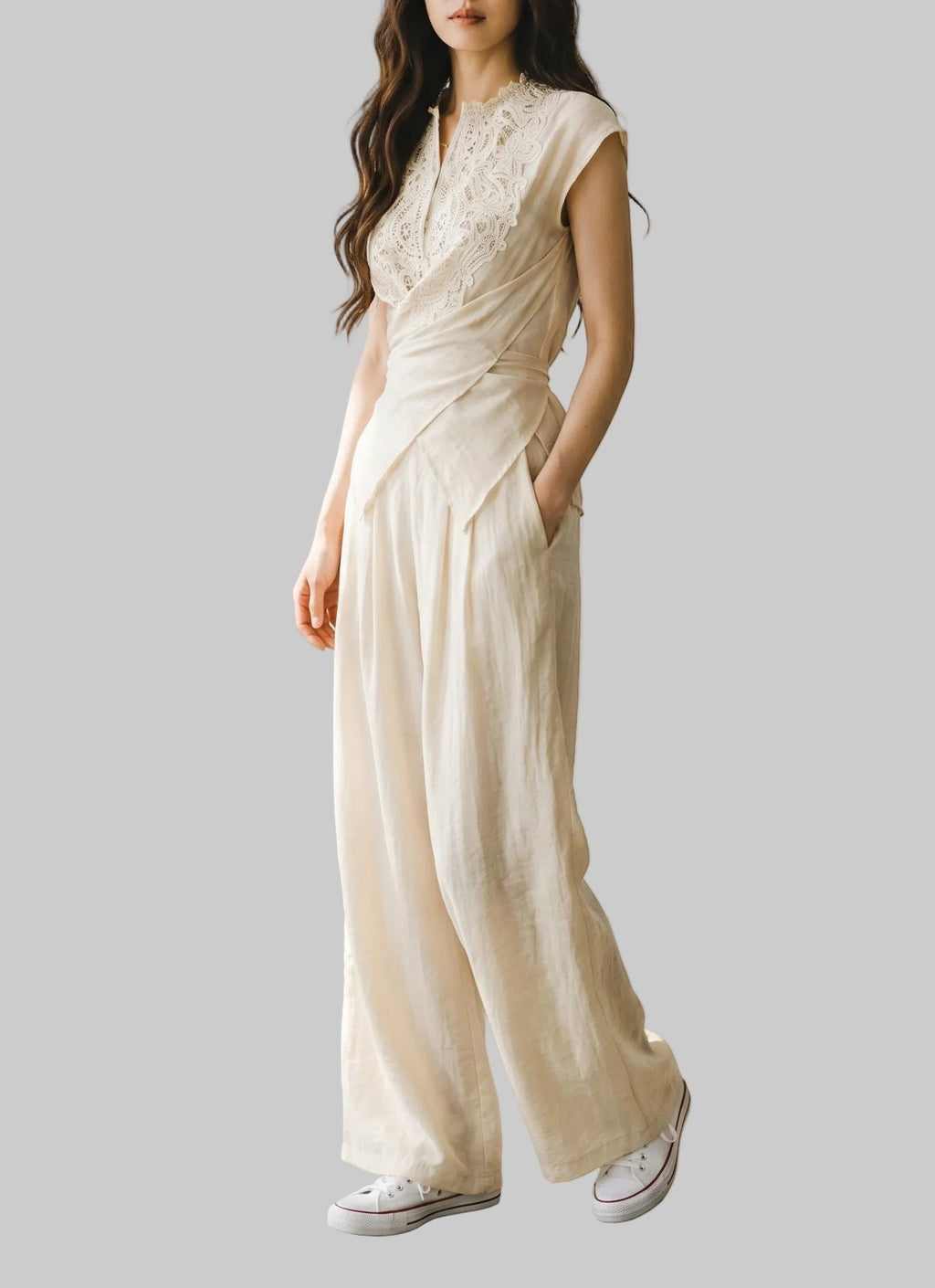 Beige linen two-piece set with a lace-trim wrap top, tie waist, and matching high-waisted wide-leg pants.