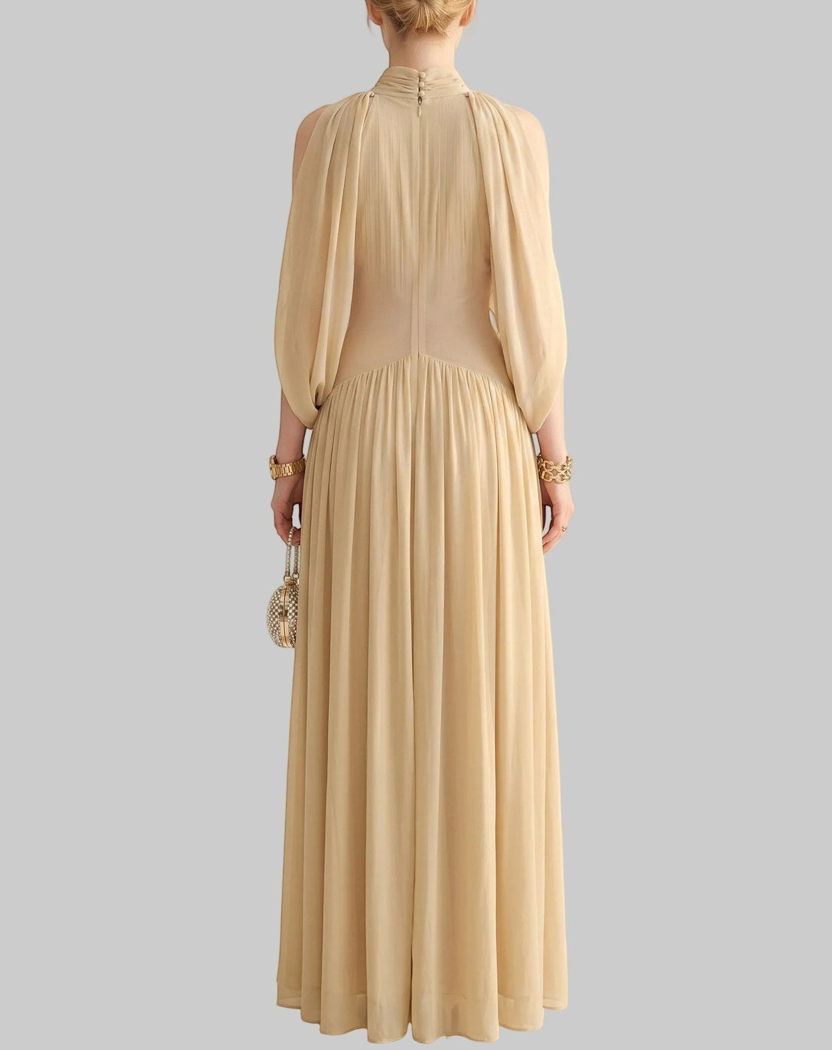 LUNRIA champagne maxi dress featuring a draped cape-style bodice, high neckline, front waist cutout, and flowing pleated skirt.