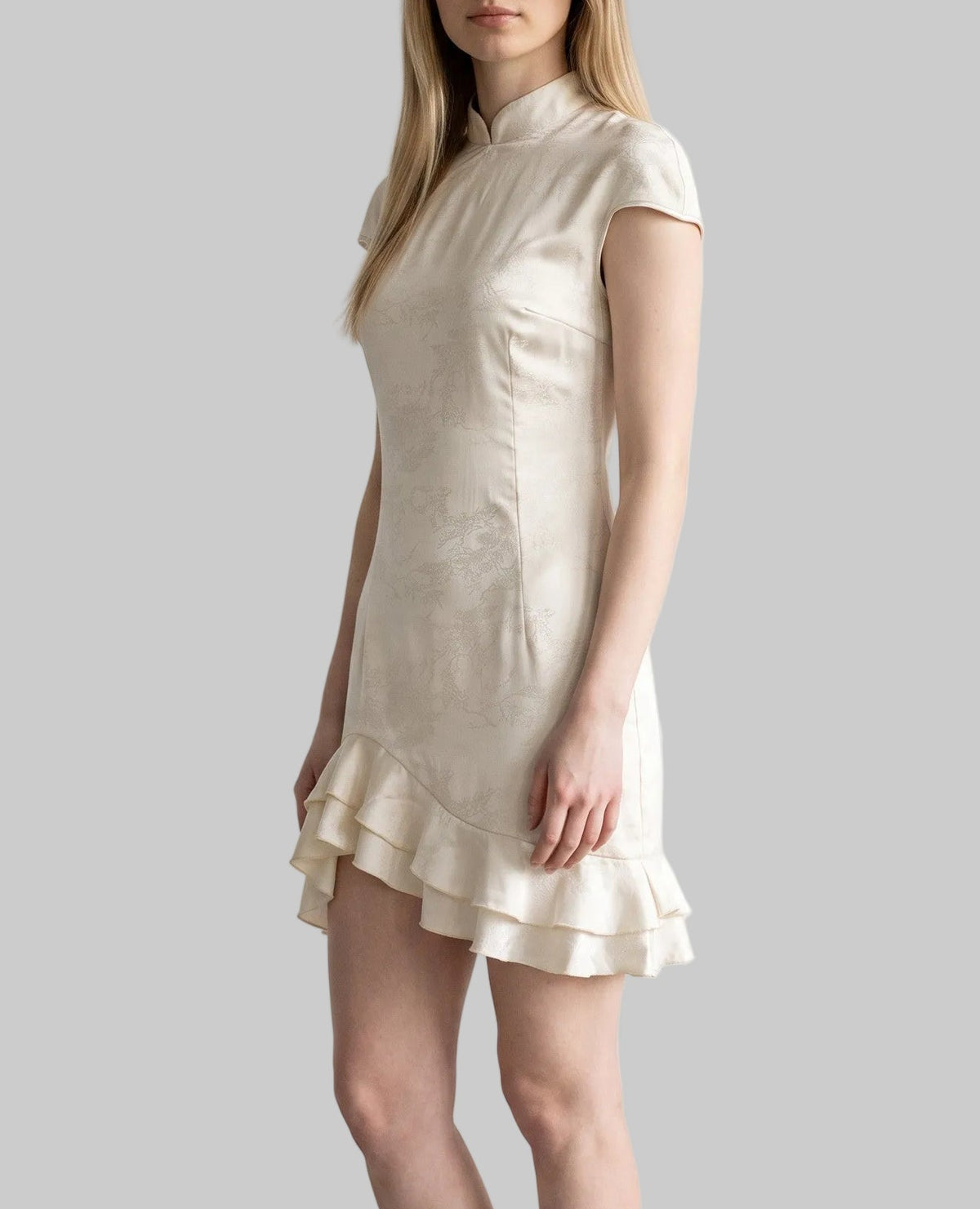 Ivory qipao mini dress with a fitted silhouette, cap sleeves and layered ruffle hem by LUNRIA.