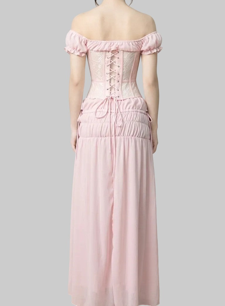 LUNRIA pink two-piece set featuring an off-shoulder lace corset top with puff sleeves and a ruched flowing maxi skirt.