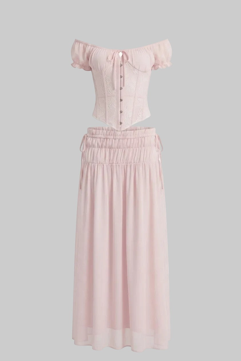 LUNRIA pink two-piece set featuring an off-shoulder lace corset top with puff sleeves and a ruched flowing maxi skirt.