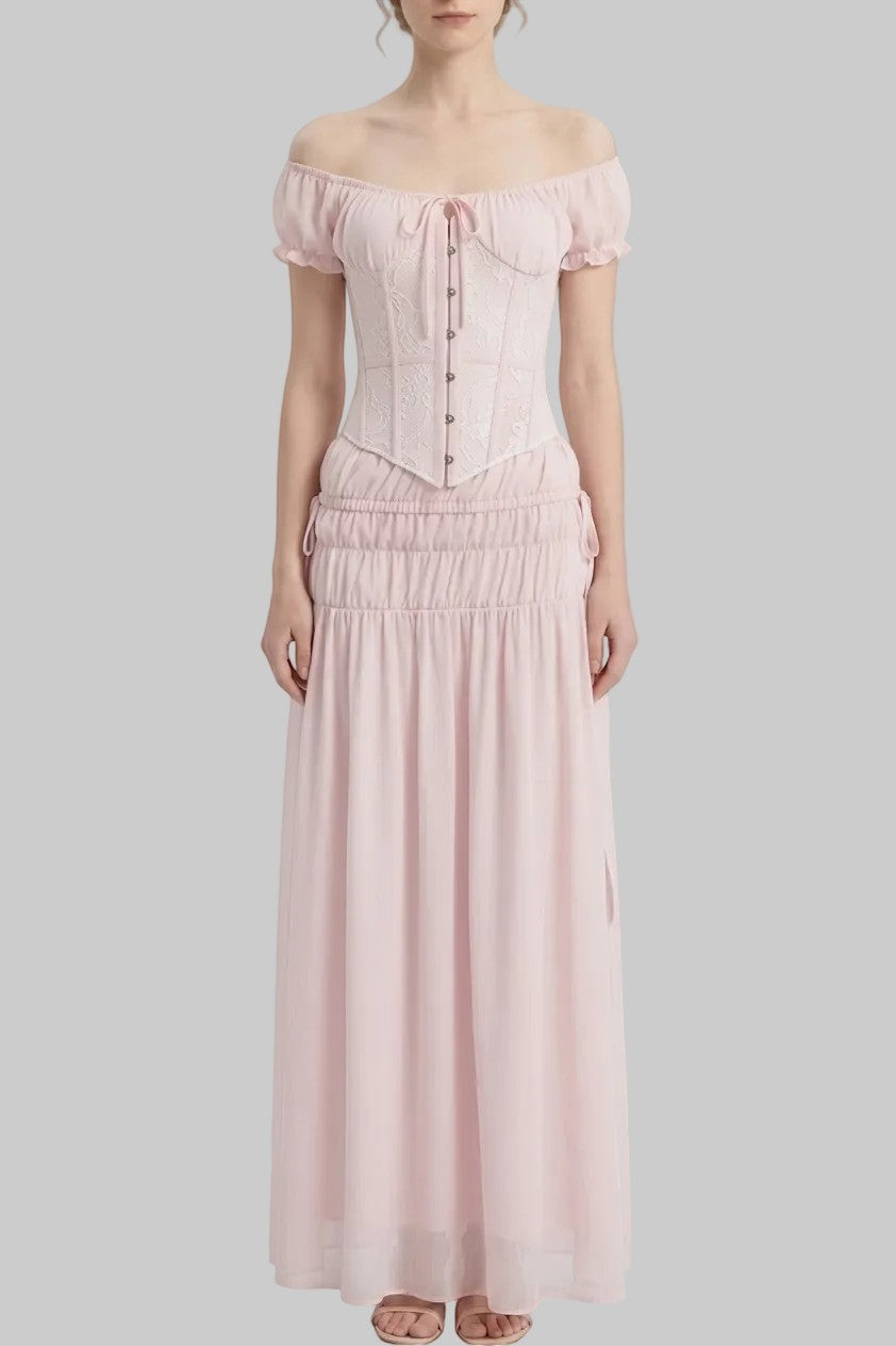 LUNRIA pink two-piece set featuring an off-shoulder lace corset top with puff sleeves and a ruched flowing maxi skirt.