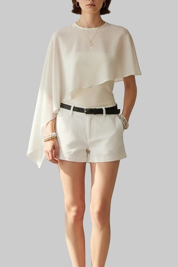 LUNRIA white asymmetric chiffon cape blouse featuring a sheer layered overlay, round neckline, and flowing draped silhouette.