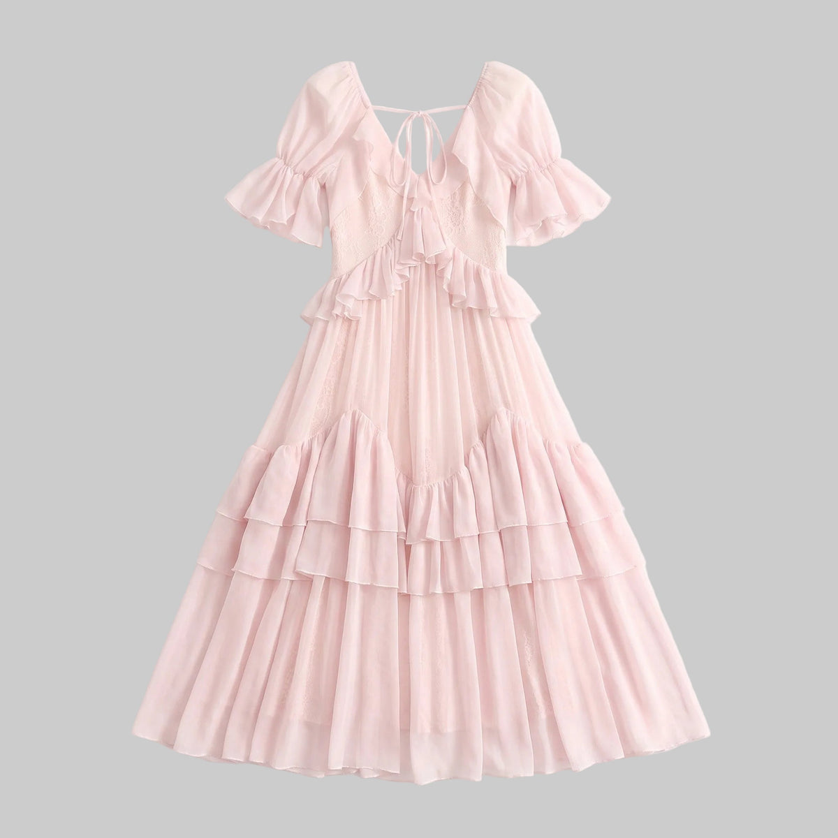 Model wearing the Rosalie pink ruffle maxi dress with tiered skirt, ruffle sleeves and bow details